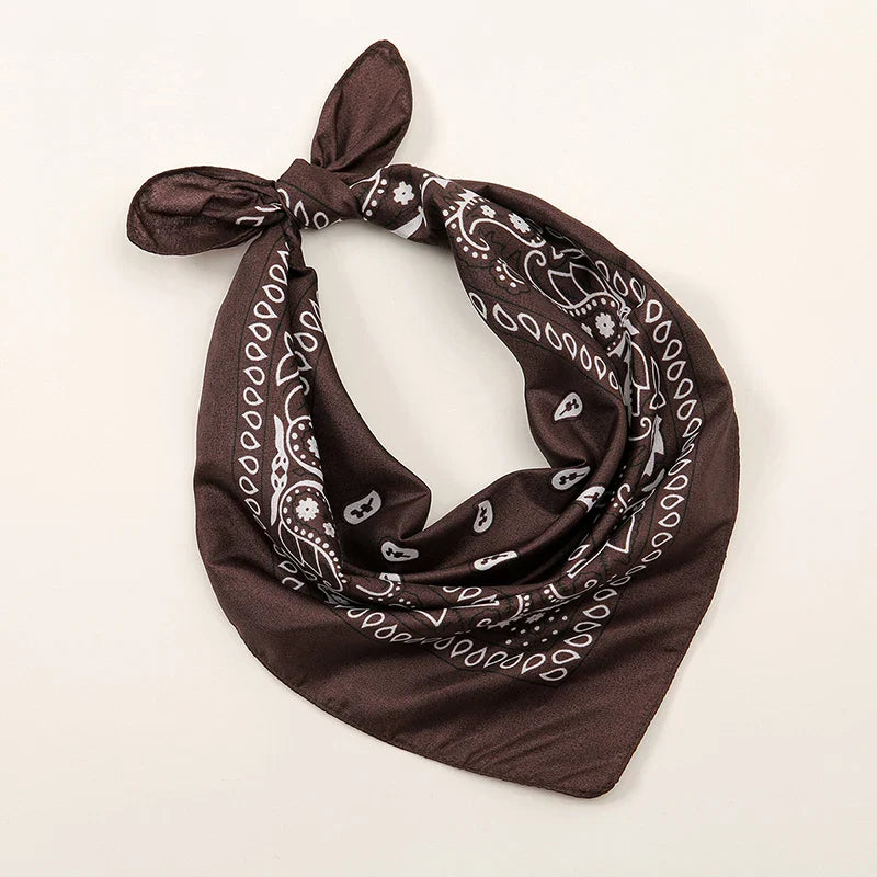 Brown bohemian print bandana with white paisley floral patterns tied in a knot for printed headbands hiphop wrist wraps face use