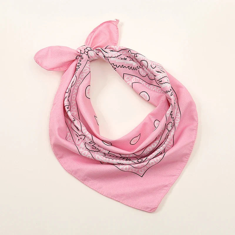 Bohemian print bandana pink with black line-drawn cartoon patterns tied in knot for printed headbands hiphop and wrist wraps face