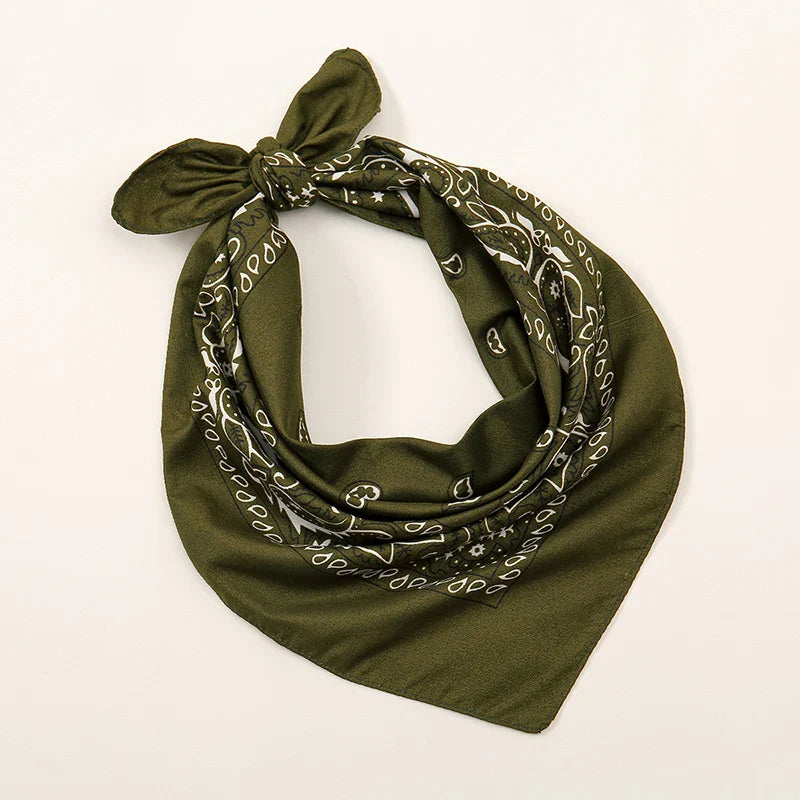 Olive green bohemian print bandana with white paisley star patterns tied in a knot for printed headbands hiphop wrist wraps face use