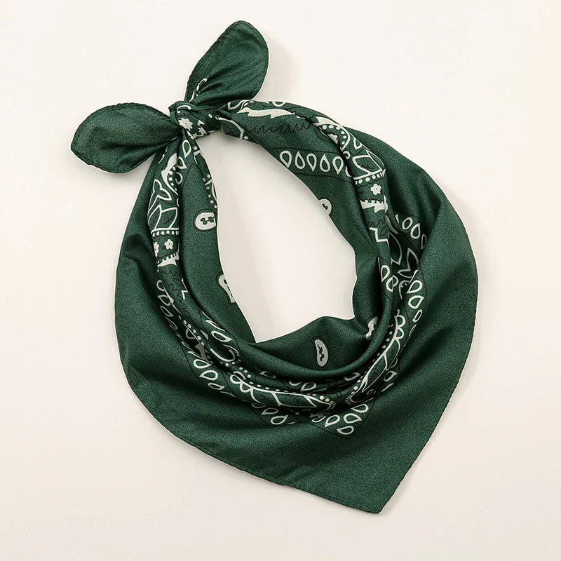 Dark green bohemian print bandana with white paisley and geometric patterns tied as a printed headbands hiphop wrap