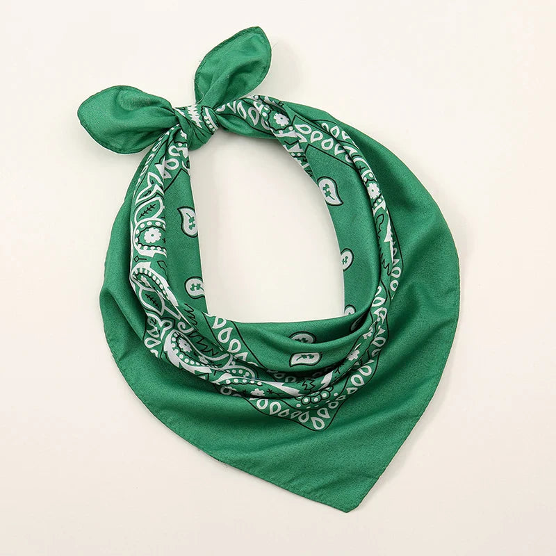 Green bohemian print bandana with white paisley pattern tied in a knot for printed headbands hiphop wrist wraps face use