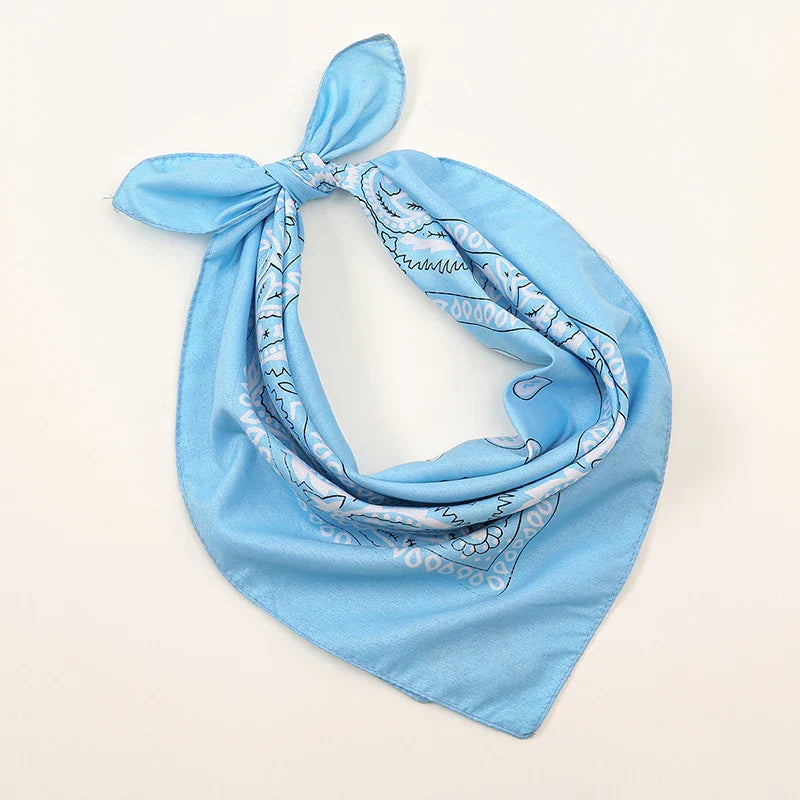 Light blue bohemian print bandana with white and gray paisley tied in a knot for printed headbands hiphop wrist wraps face use
