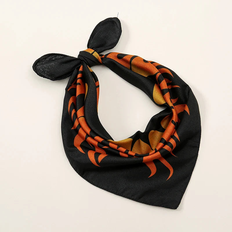 Black square bohemian print bandana with orange and gold flame patterns tied as printed headbands hiphop wrist wraps face mask