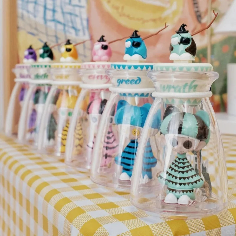 A collection of colorful cute horror figure bottle music blind toy model glow in the dark in clear glass jars with labeled lids