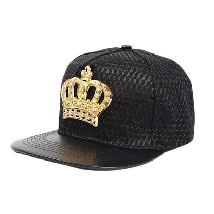 Black snapback cap with textured snakeskin fabric, glossy brim, and gold rhinestone royal king crown emblem