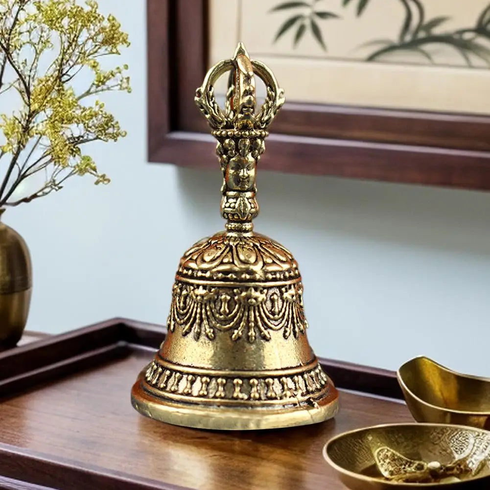 Golden brass tibetan bell with intricate engraved patterns and ornate handle in pestle set buddhist sound healing instruments