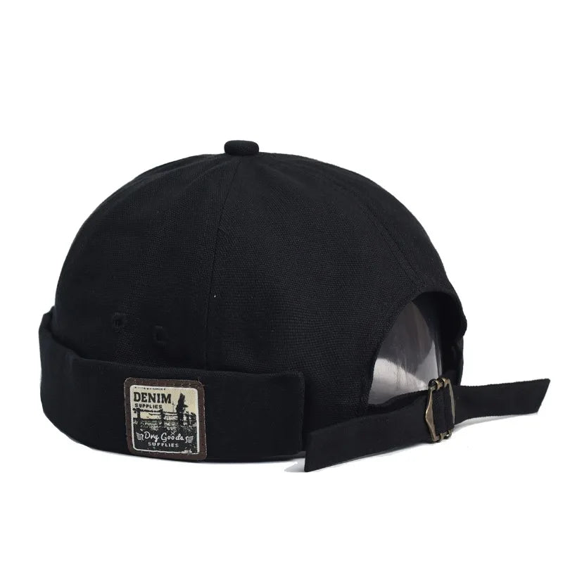 Back view of black denim british retro melon hat with folded brim and vintage patch for trendy landlord hats