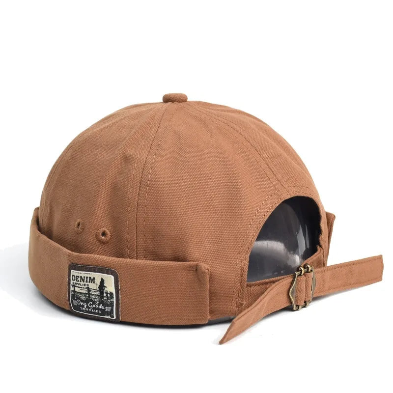 Tan denim british retro melon beret street trendy hat with folded brim and black embroidered patch on the back
