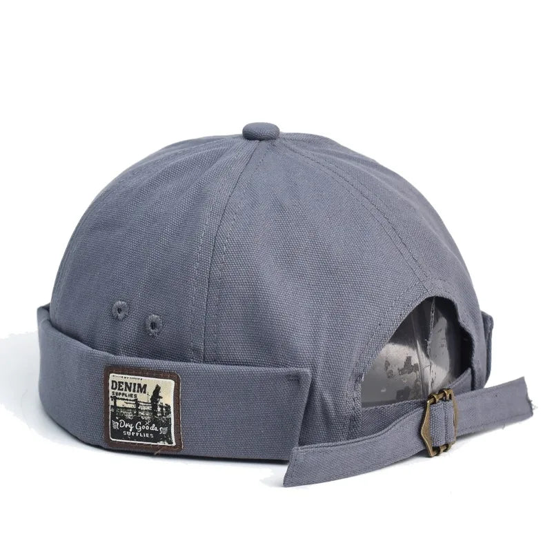 Back view of gray denim british retro melon baseball cap with folded brim and vintage patch for beret street trendy look