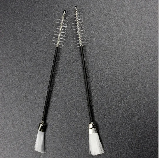 A pair of black-handled musical instrument cleaning brushes with clear bristles for alto sax clarinet flute piccolo