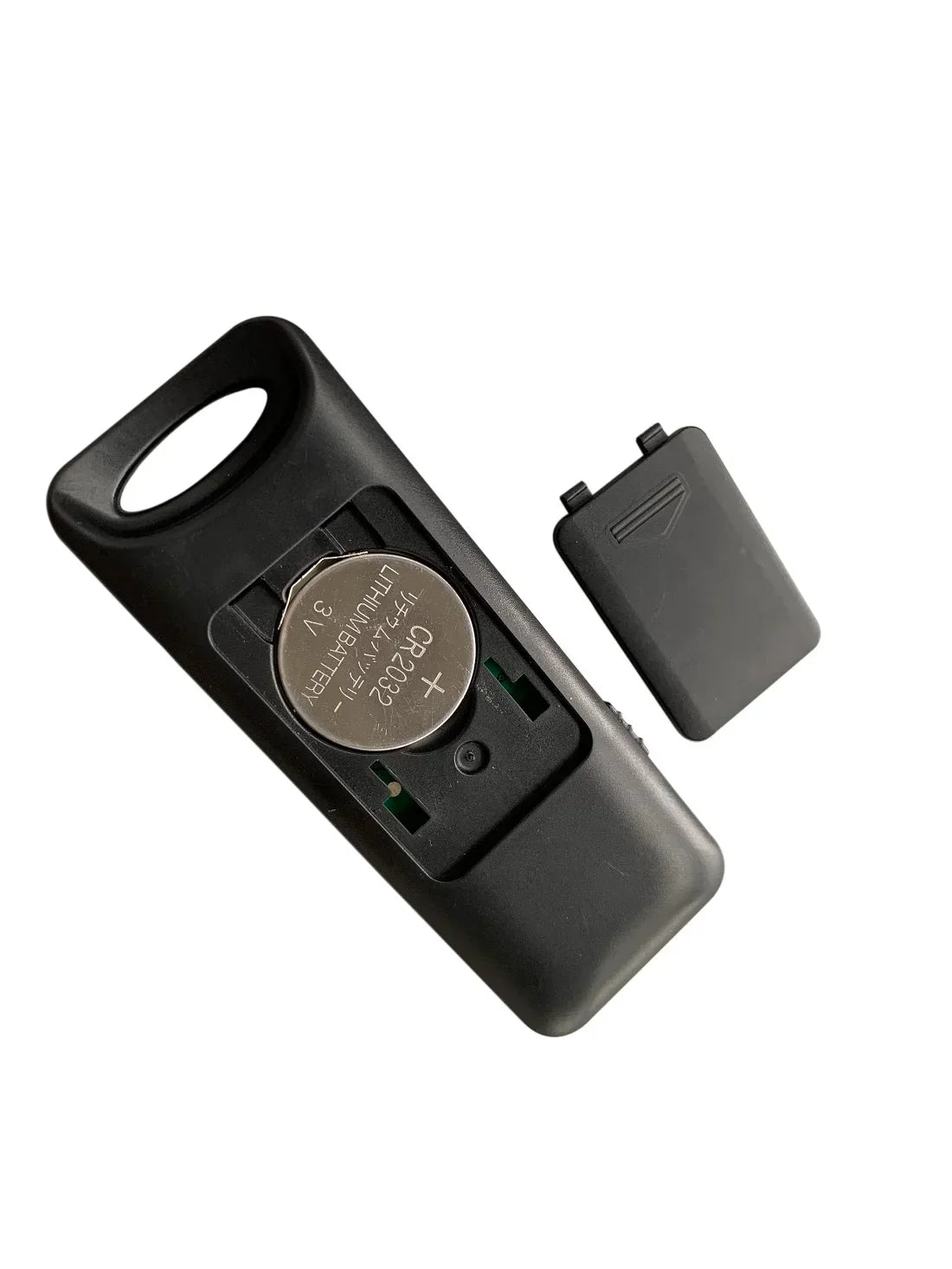 Black plastic music player remote with 3v lithium battery and detached cover showing prevtrack volume and mute fit functions