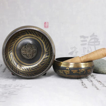 A bronze buddha sound bowl metal singing bowl with gold engraved lotus design and wooden mallet for bell yoga meditation