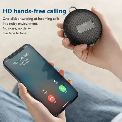 Black circular som bluetooth speaker with textured surface and small silver label wireless mini subwoofer column bocina