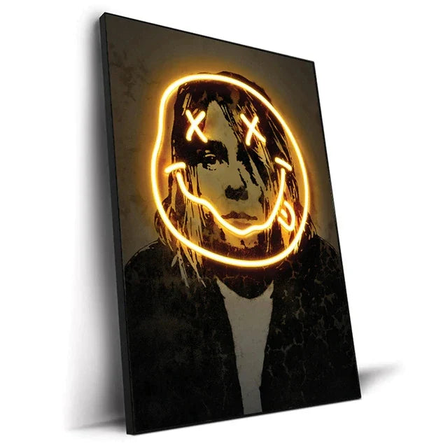 A framed canvas print featuring a neon yellow smiley face outline and stylized kurt cobain portrait on dark background