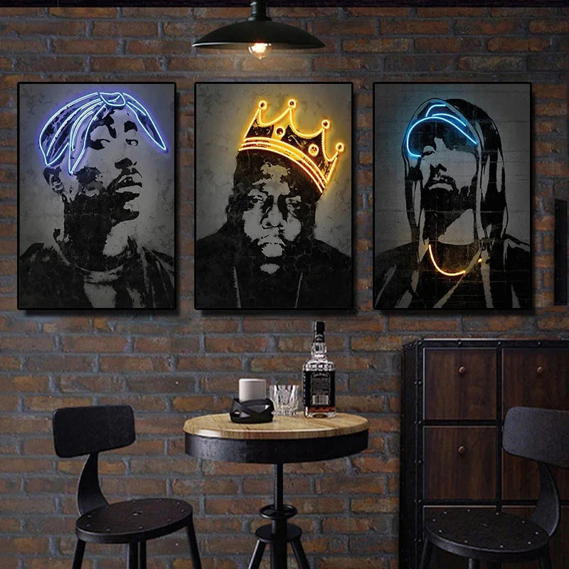 Three framed neon canvas print art posters featuring 2pac and hip hop icons with blue and gold outlines on brick wall