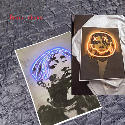 Two framed canvas print art posters featuring neon blue tupac shakur and orange glowing smiling face for hip hop decor