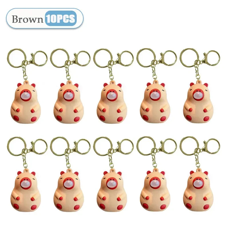 Brown pig-shaped capybara doll pinch keychains with red accents and gold clasps for spit bubble decompression and schoolbag doll pendant decoration
