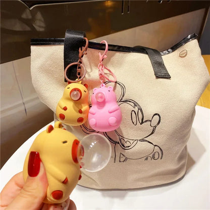 Yellow and pink capybara doll pinch music keychain toys with red accents and spit bubble decompression features for schoolbag doll pendant decoration