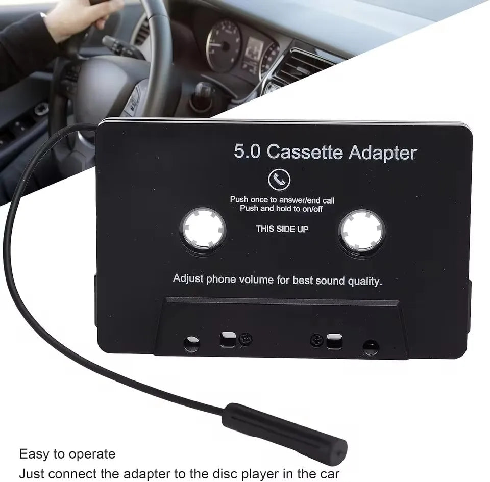 Black plastic cassette adapter with two buttons and coiled cable featuring microphone 6h music and standby smartphone cassette use