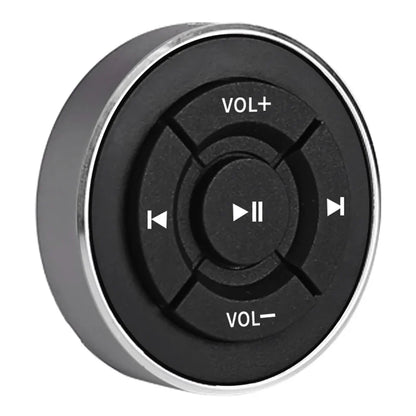 Black circular wireless bluetooth remote control car button with silver rim and white media icons for ios android use