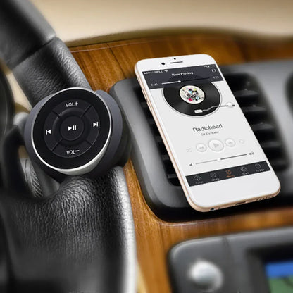 Black circular remote control car wireless bluetooth media control car kit with silver trim for ios android devices