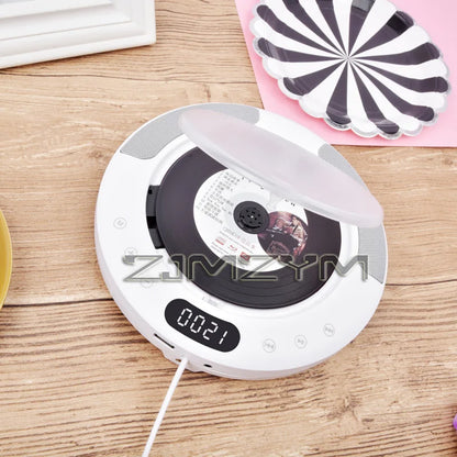 White circular cd player surround sound with transparent lid, built-in speakers, and digital display showing 00:21