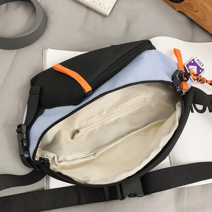 A sleek two-tone chest rig bag women nylon fanny pack streetwear with black light blue fabric and orange zipper pulls