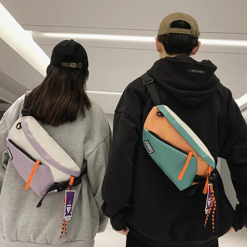 Two people wearing colorful nylon chest rig bag women with geometric design and vibrant orange zipper pulls in streetwear style
