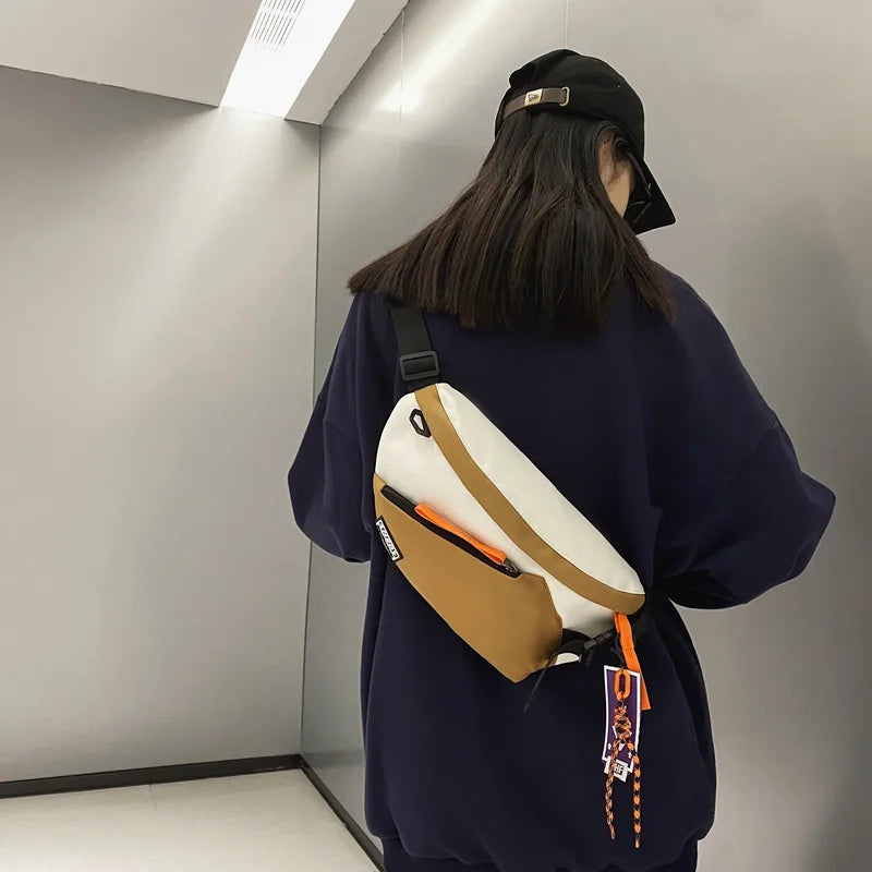 Two-tone chest rig bag women with white and tan nylon body orange zipper accents and black straps for fanny pack streetwear