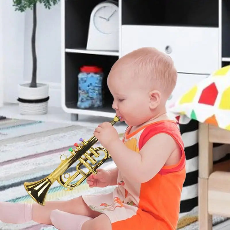 Gold-colored plastic toy trumpet musical instrument with colorful buttons and shiny simulated musical brass finish for house music equipment