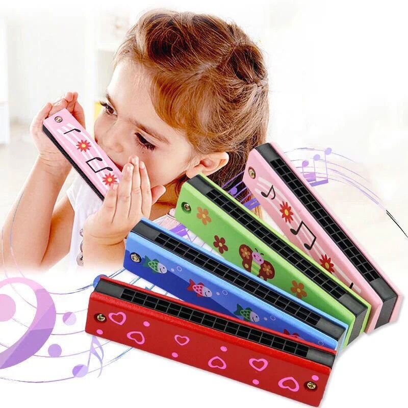 A child holds a pink children wooden harmonica with floral design next to colorful toys music teaching aids