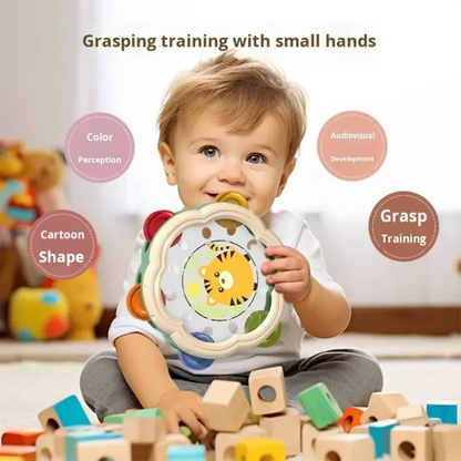 A child holds a colorful wooden bell drum percussion with a yellow tiger face for early education puzzle fun hand clapping