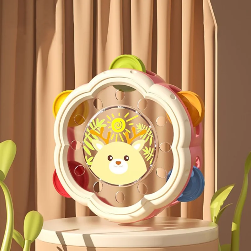 A colorful plastic flower-shaped baby rattle with a yellow deer face and rainbow bells for fun hand clapping