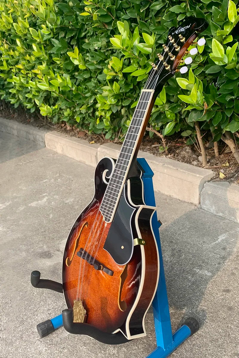 Aiersi brand mandolin handmade vintage with sunburst finish and black pickguard on blue stand bluegrass acoustic archtop