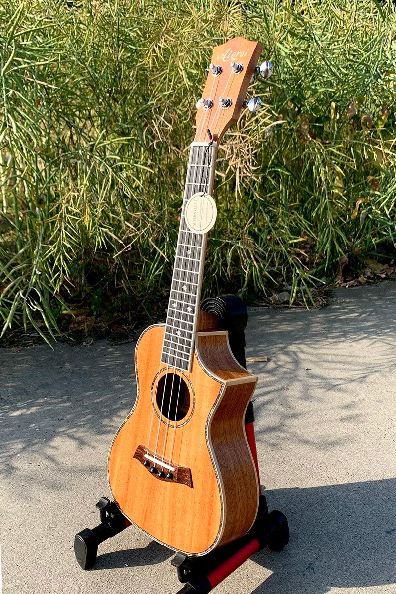 Aiersi brand light brown wood 24 inch concert ukulele custom with glossy finish and black fretboard on red stand