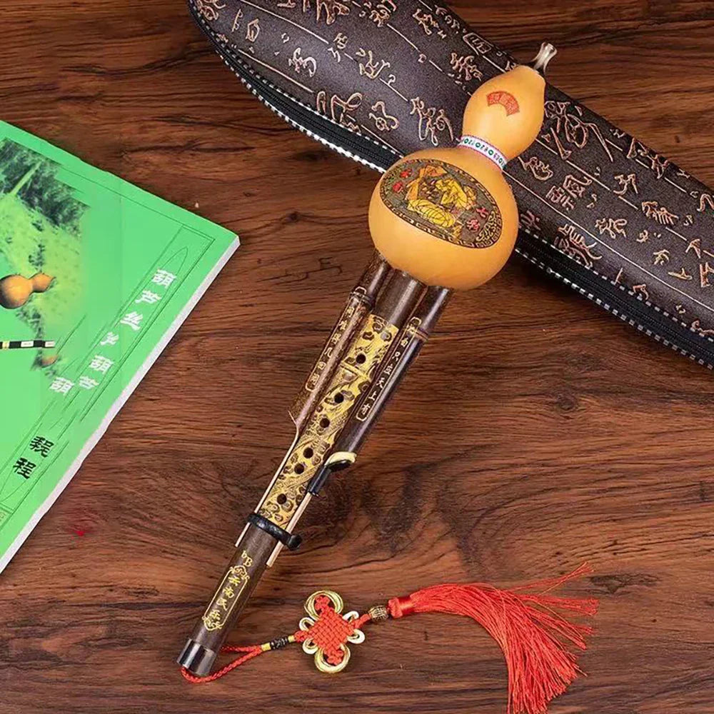 Chinese handmade hulusi with natural tan gourd body, gold inlay wood pipes, red tassels, cucurbit c tune for beginner music lovers
