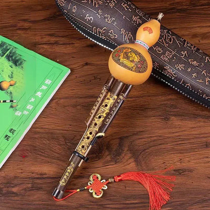Chinese handmade hulusi with natural tan gourd body, gold inlay wood pipes, red tassels, cucurbit c tune for beginner music lovers
