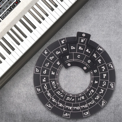 Black wooden circle of fifths guitar chord wheel with white lettering and raised tabs for music theory reference