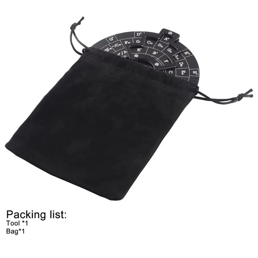 Black suede drawstring bag containing a black circular wooden guitar chord wheel music theory tool with white lettering