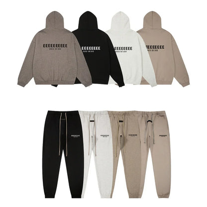 Image of the back side of a classic brand hoodies and jogger set in muted tones with bold black lettering made of quality fleece sweatshirts for hiphop streetwear oversize looks