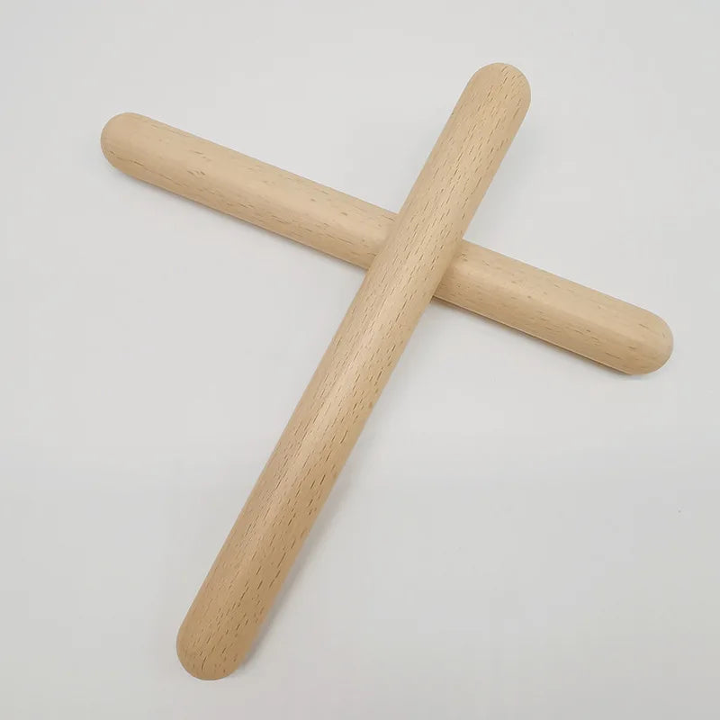 Two light-colored wooden classic claves rhythm sticks with smooth rounded ends for kid children musical use