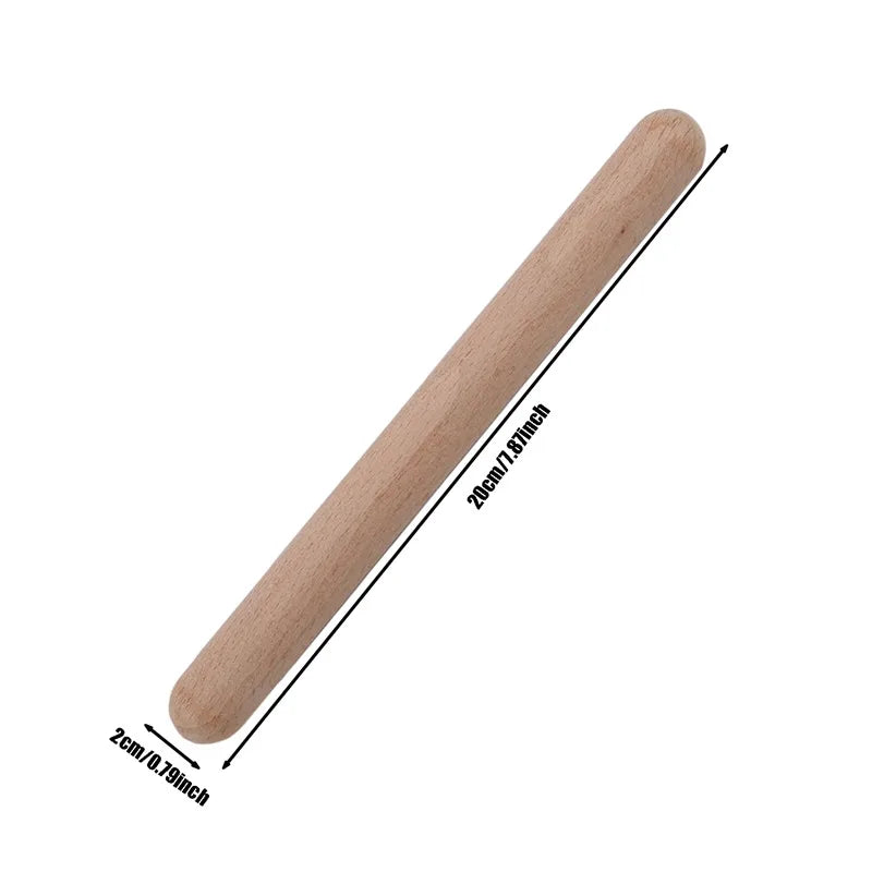 A smooth light-colored wooden classic claves rhythm percussion instrument kid stick with natural wood grain finish