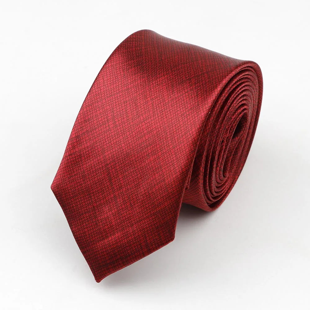 A sleek deep red silk skinny tie with subtle textured weave suitable as a colorful musical notes width necktie party accessory