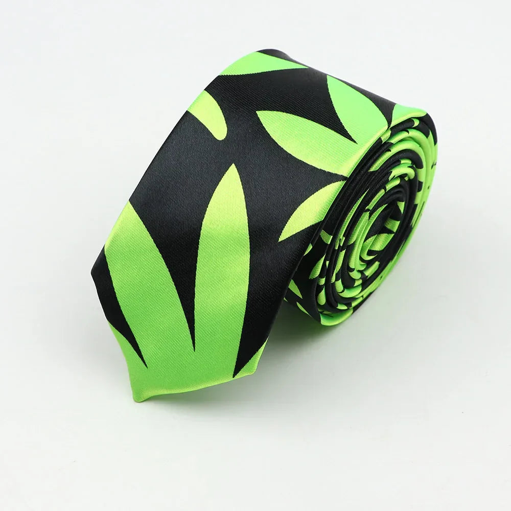 A sleek neon green and black silk skinny tie colorful leaf pattern neatly coiled for width necktie party accessory