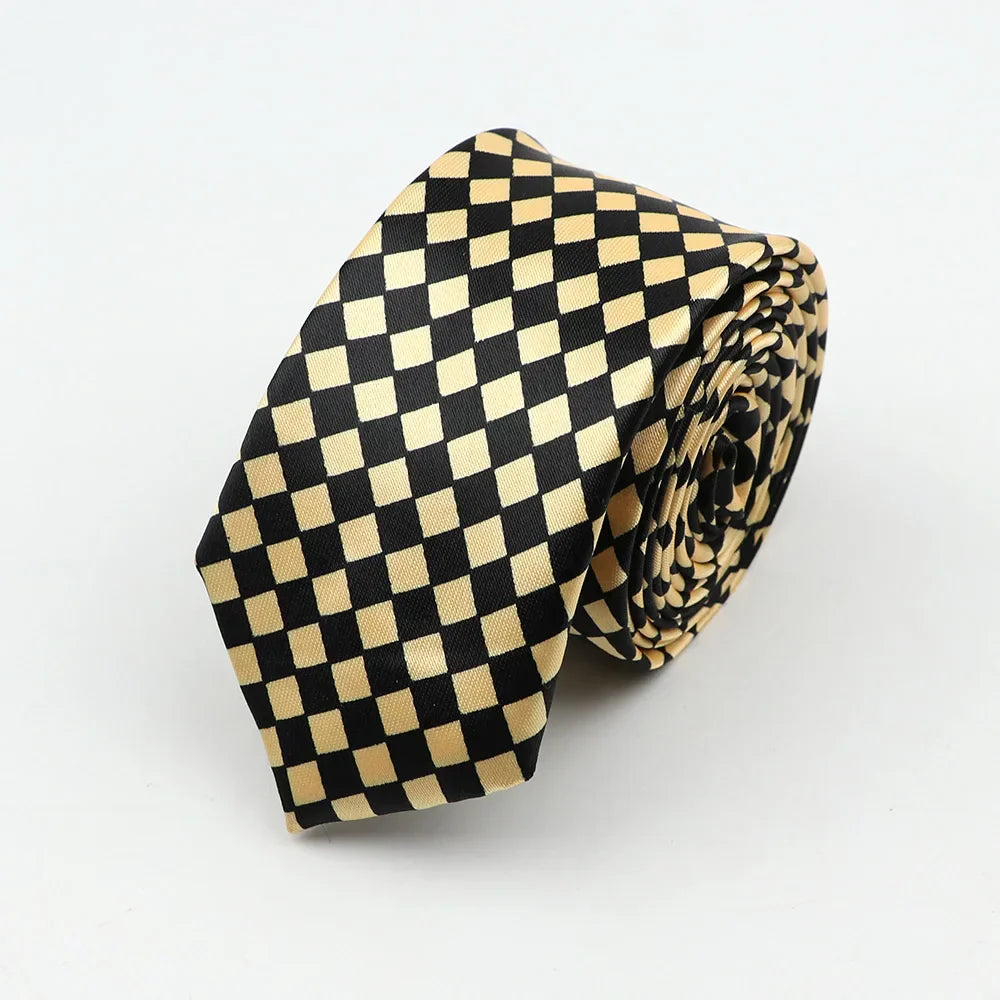 A sleek black and gold checkered silk skinny tie colorful necktie party accessory neatly rolled for display