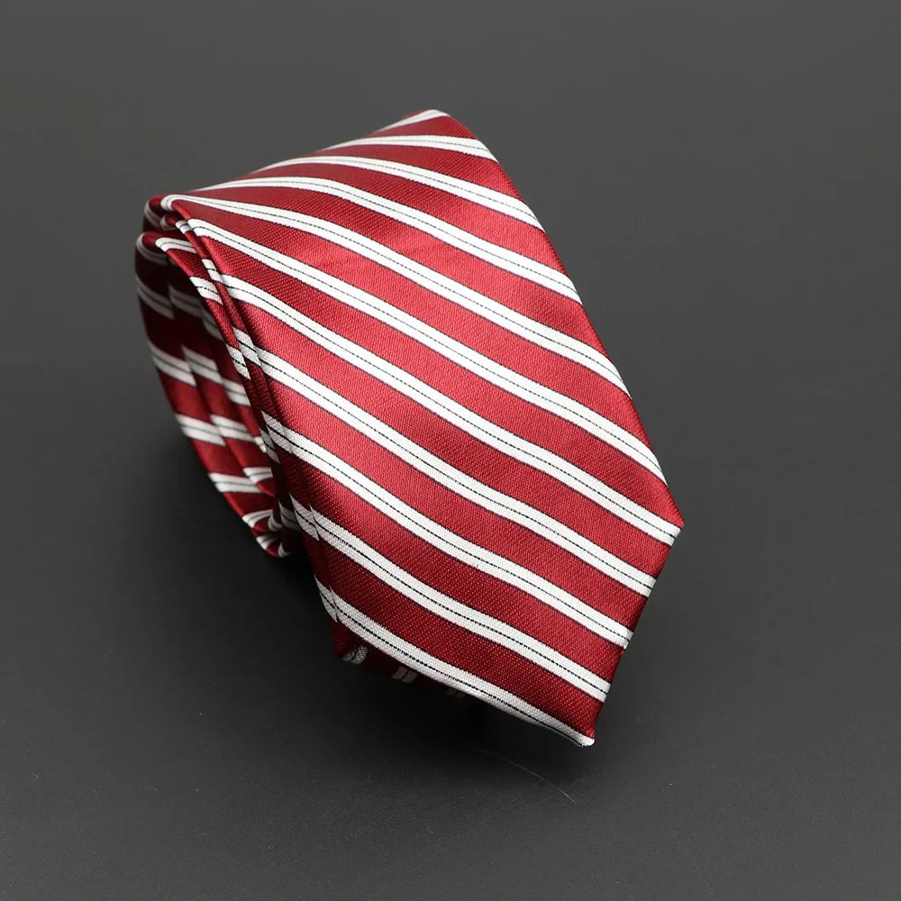 A neatly folded red and white diagonally striped silky narrow necktie perfect as a classic musical notes gift accessory