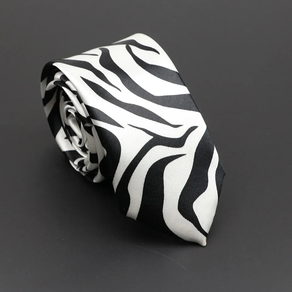 A sleek black and white classic musical notes printed tie made of silky narrow neckties elegantly rolled for display