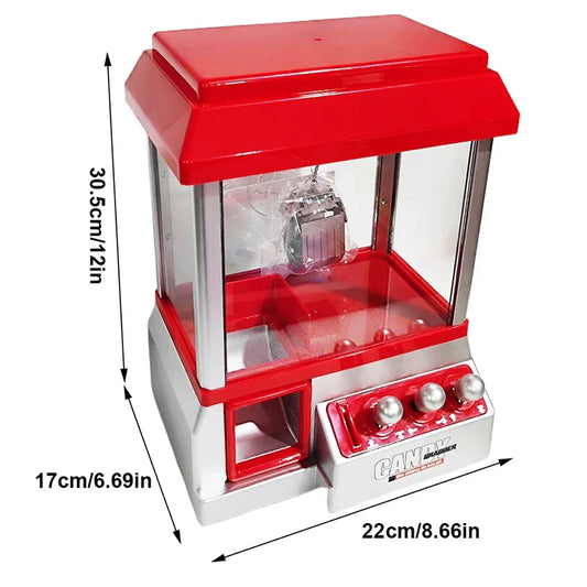 Red and silver claw machine electronic candy machine arcade with transparent glass sides and three front round buttons