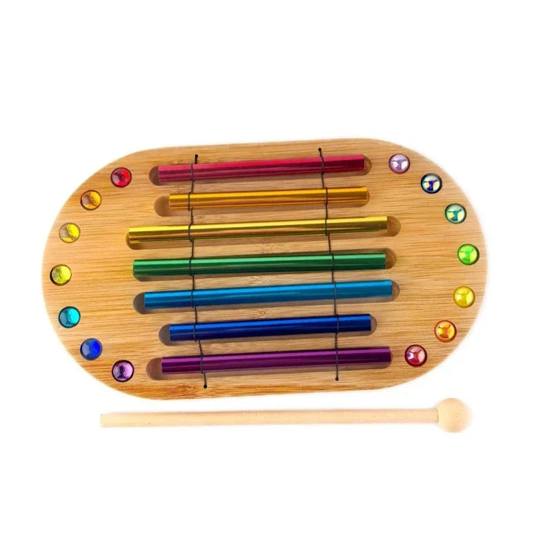 Rainbow-colored metallic bars in bamboo frame with gemstone accents and mallet for meditation spiritual healing energy percussion instruments
