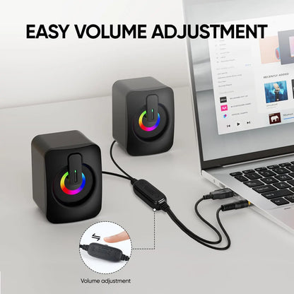 Black cube-shaped computer speaker with rainbow led lighting and top volume slider for aux home office and macbook desktop notebook use